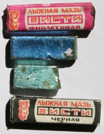 Иван Исаев Это – воспоминание 40-летней давности периода моих старших школьных классов. Когда я написал в этой заметке о мазях Висти, вдруг задумался: а выпускают ли их сегодня? Потом полез в старую коробку с надписью «лыжные мази» и, о чудо, нашёл эти брикетики лыжной мази в тонюсенькой фольге разного цвета. Этим брикетикам уже по четыре десятка лет, их выпускали во второй половине 70-х, когда Москва выиграла право на проведение Олимпиады 1980 года и вся спортивная атрибутика, снаряжение, экипировка стали выпускаться в стране с олимпийской символикой (олимпийского мишку видите?). Как видите, фольга имеет разный цвет – по погоде. 0 – 2 (фиолетовая лыжная мазь), - 2 – 8 (голубая лыжная мазь), - 5 – 12 (светло-зеленая лыжная мазь), - 10 – 25 (тёмно-зеленая лыжная мазь (этого брикетика нет на снимке, его не оказалось в моей домашней коллекции)), - 15 – 30 (чёрная лыжная мазь). Отчётливо помню, что потом производитель сильно упростил процедуру упаковки, и фольга на всех брикетиках стала одного, серебристого, цвета, и мы, чтобы не путаться, выдавливали в нижней части брикетика на фольге шариковой ручкой температурный диапазон применения данной конкретной мази. Конечно, эти лыжные мази были не настолько удобны, как импортные, они не имели удобной крышечки, да и фольга у этих брикетиков была тонюсенькой-тонюсенькой. Но мы, мальчишки 70-х, их очень любили. Эти мази были доступны, и нам хотелось верить, что по своим качествам они совершенно не уступали своим импортным аналогам. Я, пожалуй, даже сегодня, с высоты своих лет, опыта и спортивной квалификации не побоюсь сказать, что они, действительно, были очень хороши и смазка наших лыж нас всегда устраивала.